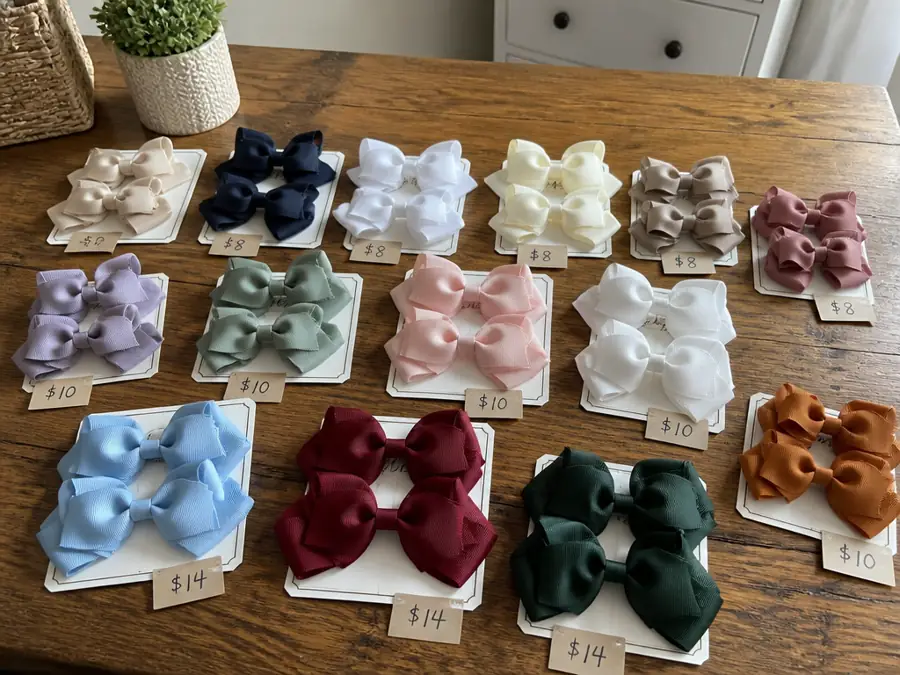 Hair bows on display cards with prices